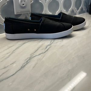 Avalon coated black canvas slip on sneakers from Tom’s